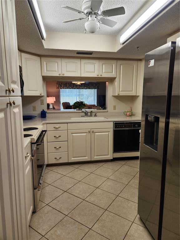 6503 Stone River Road, Unit 109 Bradenton, FL 34203 - Photo 8 of 39 a kitchen with stainless steel appliances granite countertop a sink stove and refrigerator