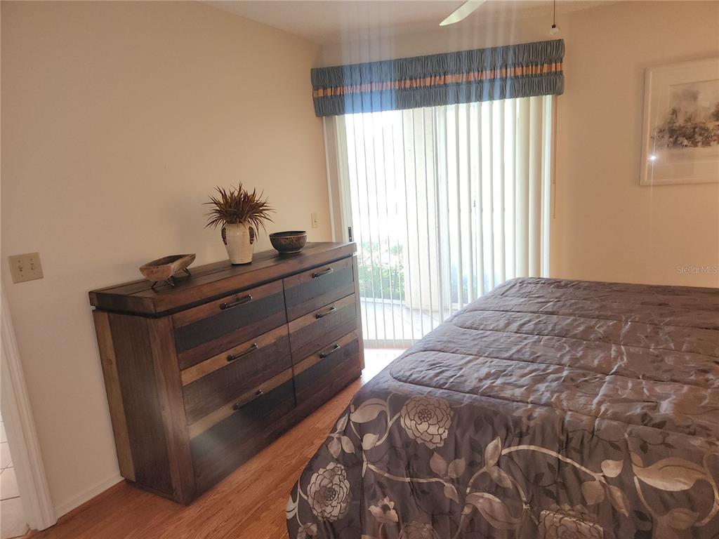 6503 Stone River Road, Unit 109 Bradenton, FL 34203 - Photo 10 of 39 a bed sitting in a bedroom next to a window