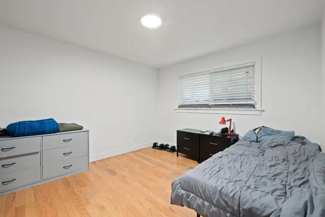 a bedroom with a bed and a dresser