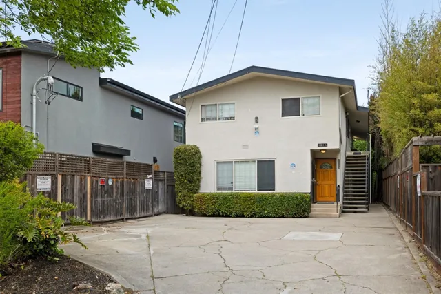 a view of a house with wooden fence