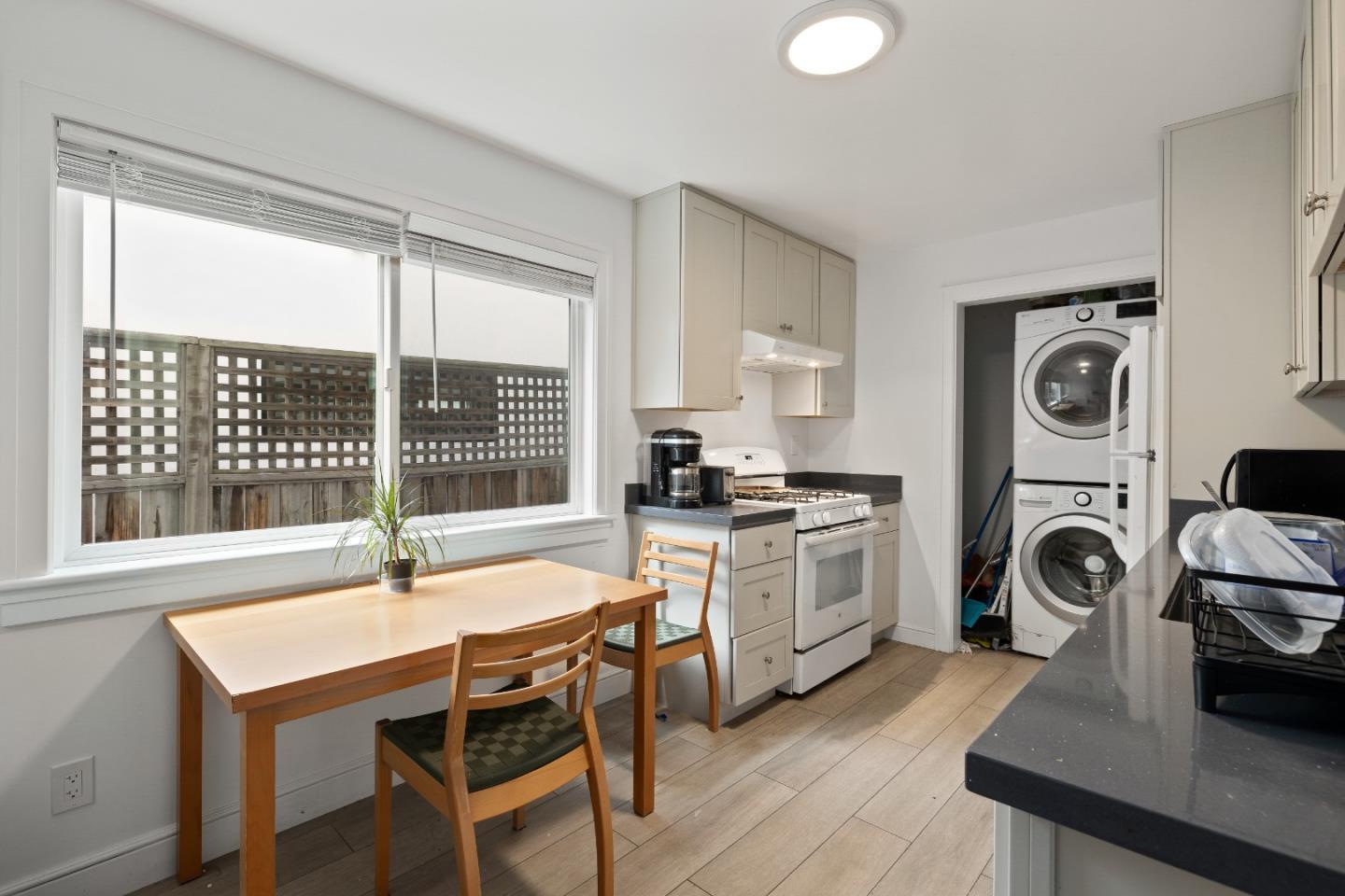 1819 Carleton Street Berkeley, CA 94703 - Photo 6 of 14 a kitchen with a table chairs stove and sink