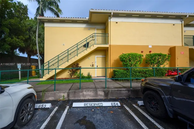 a view of a street with cars parked