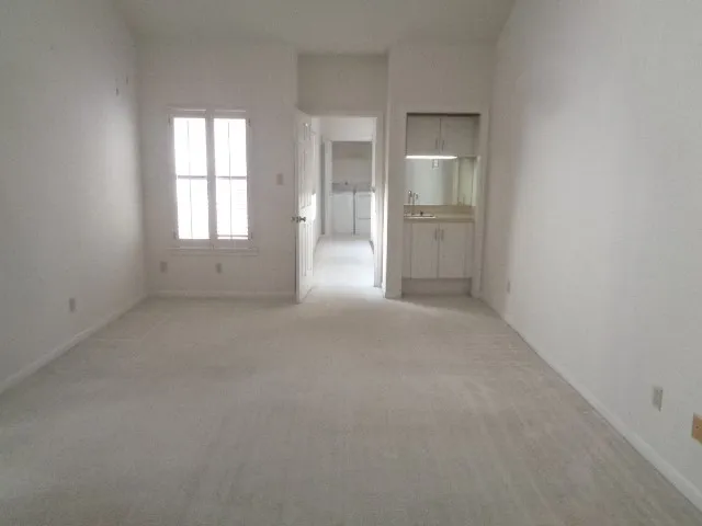 an empty room with windows and entrance