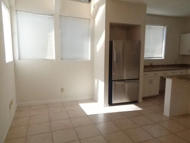 a view of a kitchen with a sink and a refrigerator