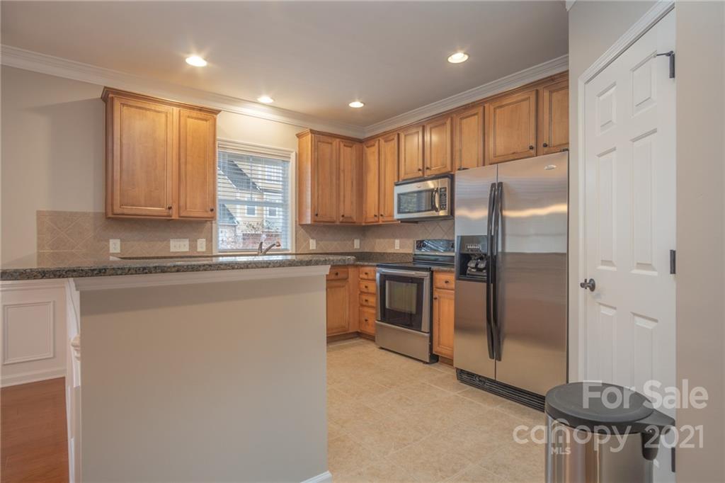 625 Sunfish Lane Tega Cay, SC 29708 - Photo 14 of 48 a kitchen with stainless steel appliances granite countertop a refrigerator a stove and a sink