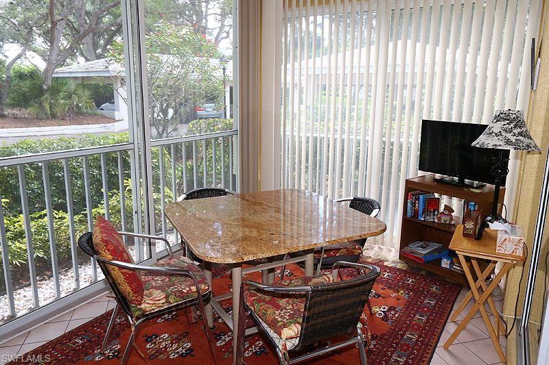 784 Willowbrook Drive, Unit 601 Naples, FL 34108 - Photo 14 of 20 a room with furniture and a flat screen tv