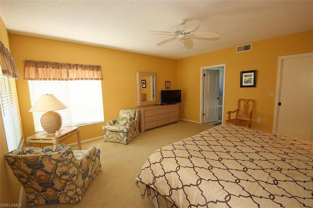 784 Willowbrook Drive, Unit 601 Naples, FL 34108 - Photo 20 of 20 a spacious bedroom with a bed and dresser