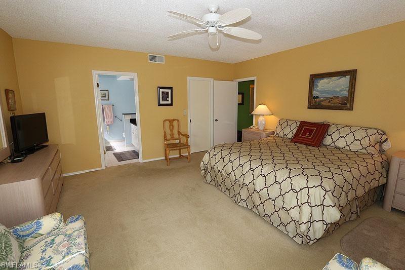 784 Willowbrook Drive, Unit 601 Naples, FL 34108 - Photo 3 of 20 a bedroom with a bed and a tv