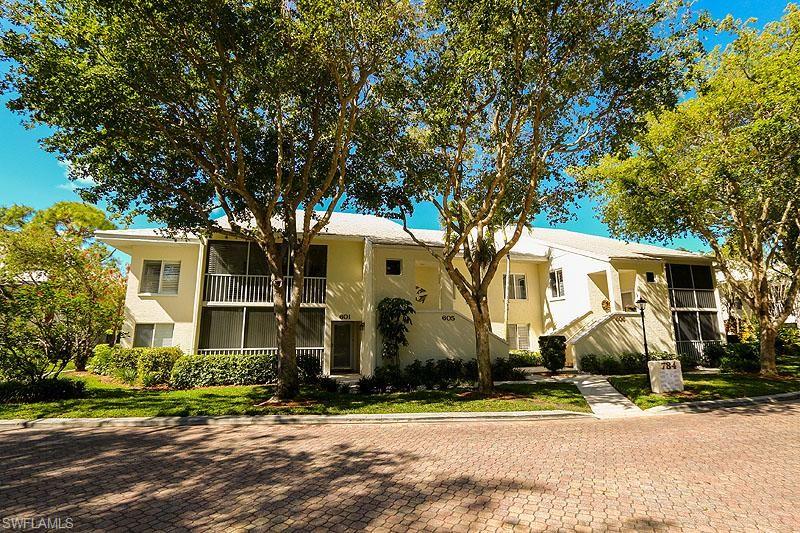 784 Willowbrook Drive, Unit 601 Naples, FL 34108 - Photo 7 of 20 front view of a house with a yard