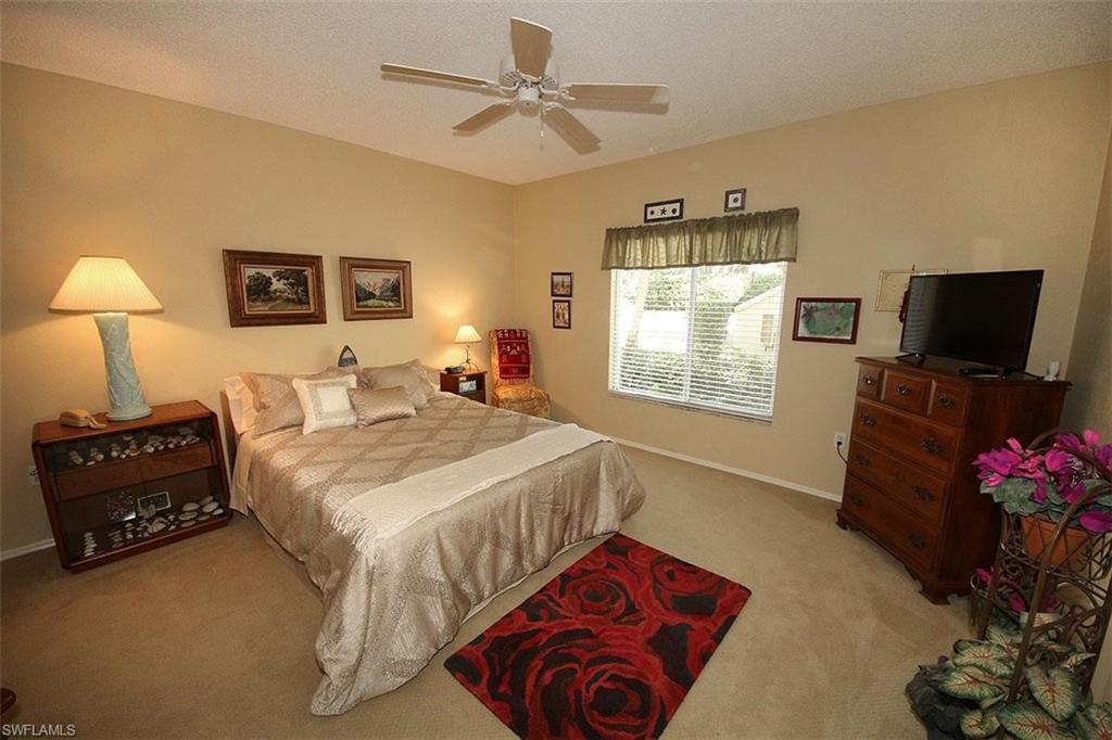 784 Willowbrook Drive, Unit 601 Naples, FL 34108 - Photo 9 of 20 a bedroom with a bed window and a flat screen tv