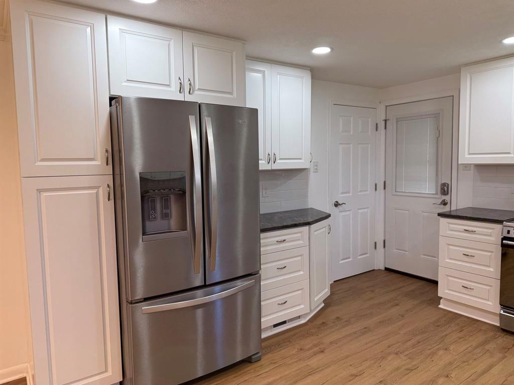 27 Corbett Avenue Irwin, PA 15642 - Photo 13 of 39 a kitchen with white cabinets and stainless steel appliances