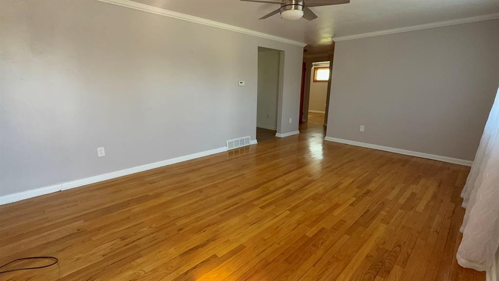 27 Corbett Avenue Irwin, PA 15642 - Photo 15 of 39 a view of an empty room with wooden floor and a ceiling fan