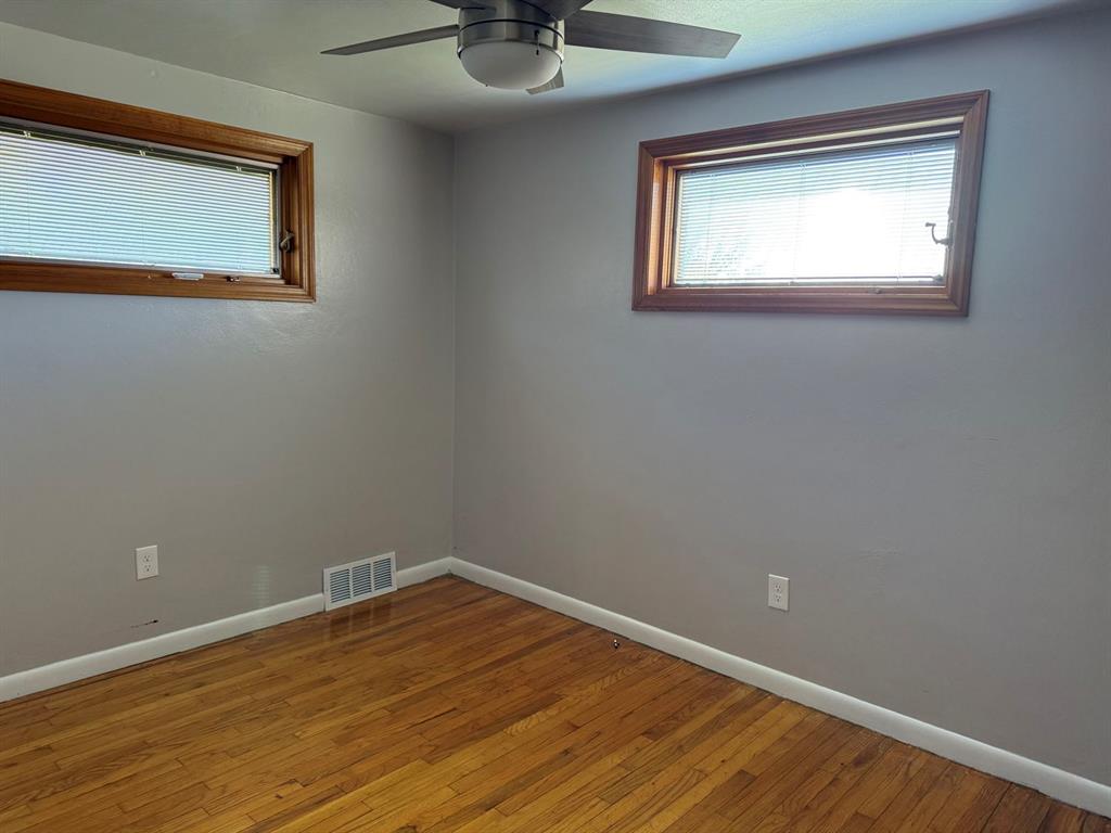 27 Corbett Avenue Irwin, PA 15642 - Photo 16 of 39 a view of an empty room with a window and wooden floor