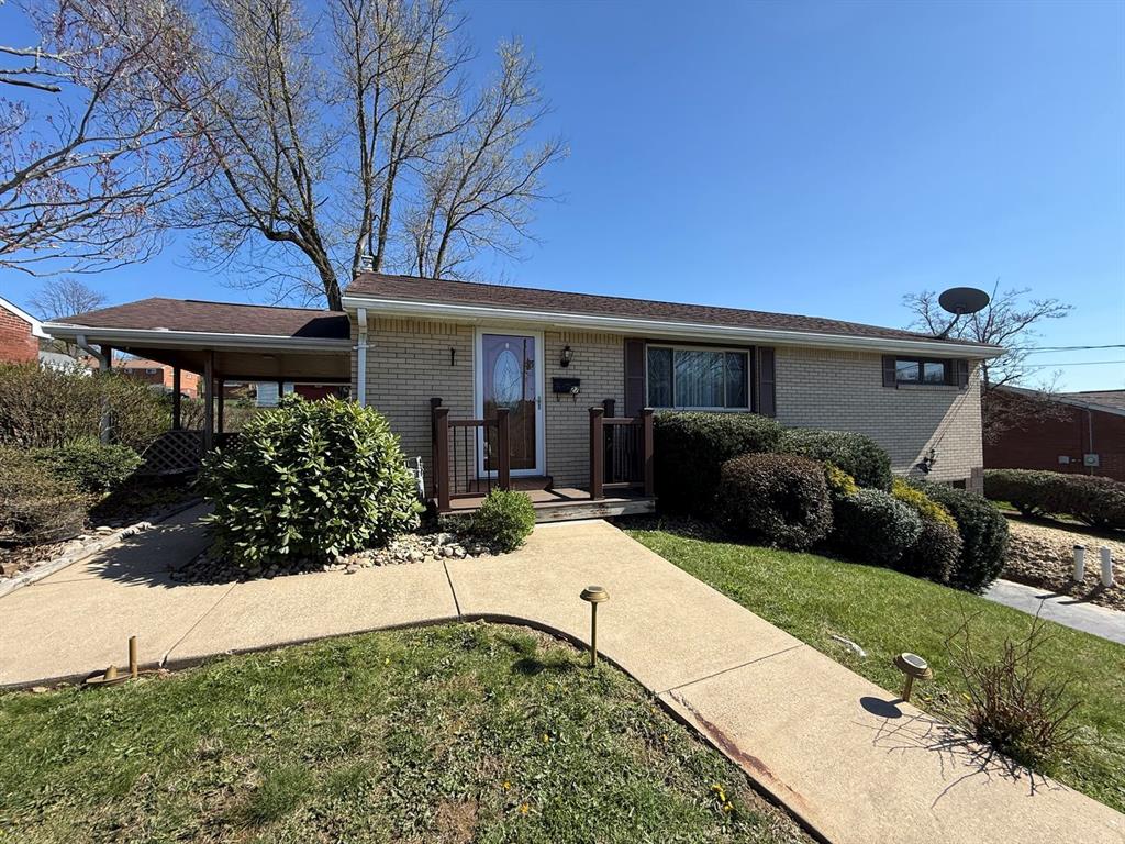 27 Corbett Avenue Irwin, PA 15642 - Photo 2 of 39 a front view of a house with garden