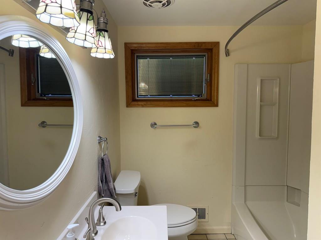 27 Corbett Avenue Irwin, PA 15642 - Photo 21 of 39 a bathroom with a toilet sink and mirror