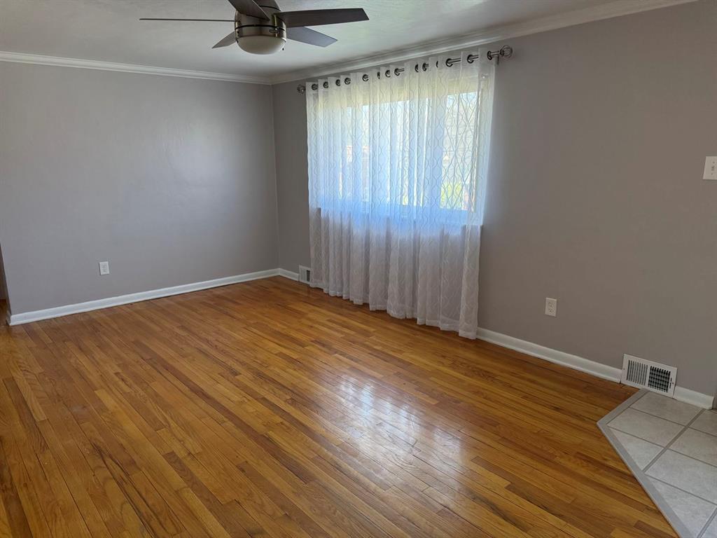 27 Corbett Avenue Irwin, PA 15642 - Photo 6 of 39 an empty room with wooden floor and windows