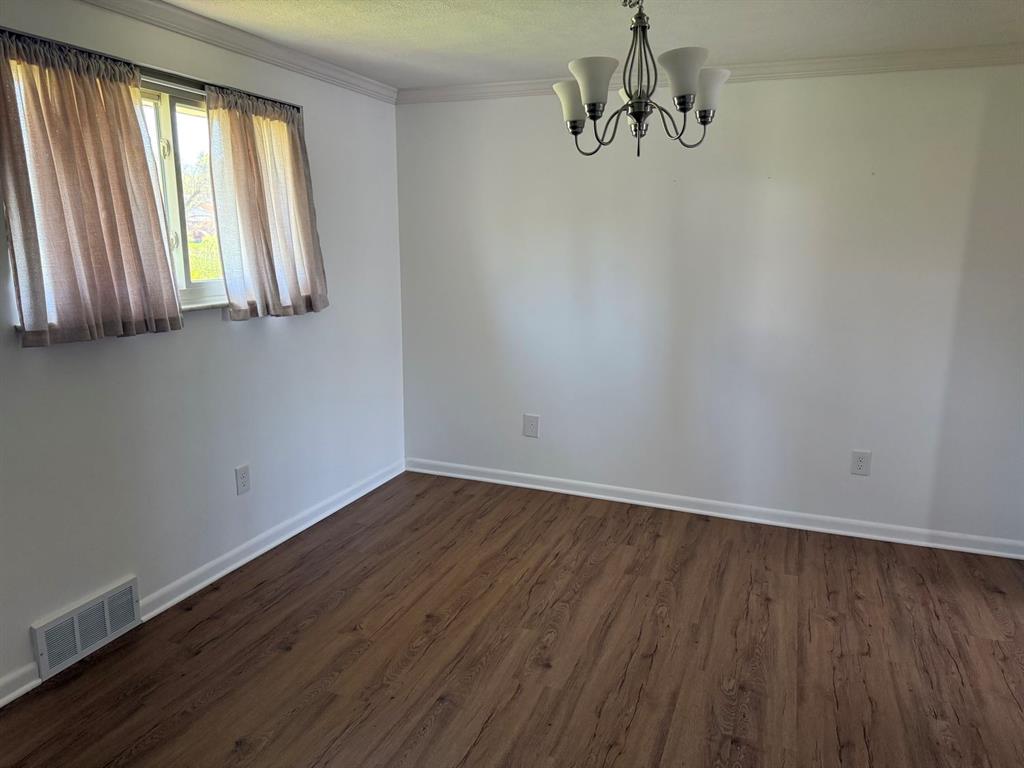 27 Corbett Avenue Irwin, PA 15642 - Photo 8 of 39 a view of a room with wooden floor and window