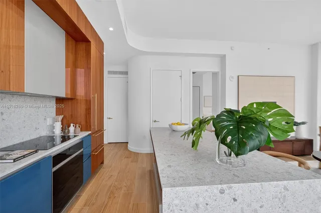 a kitchen with a potted plant on the counter and cabinets