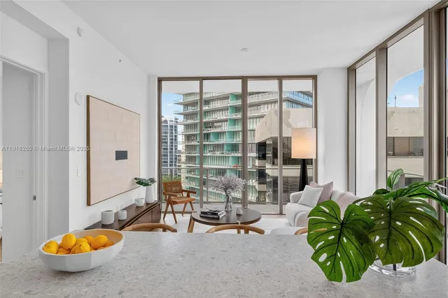 a living room with patio area and swimming pool