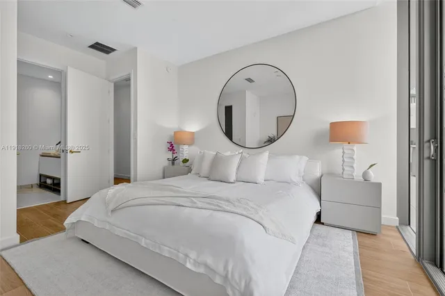 a bedroom with bed and a mirror