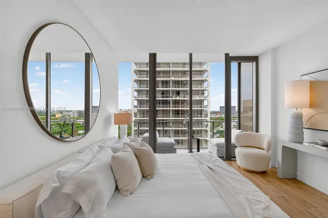 a bedroom with a large bed and a large window