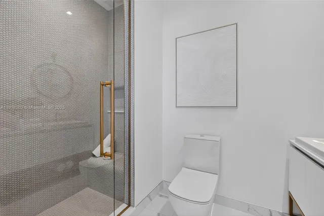 a bathroom with a toilet and a shower