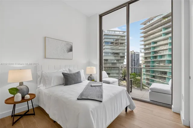 a bedroom with a bed and a couch next to a window