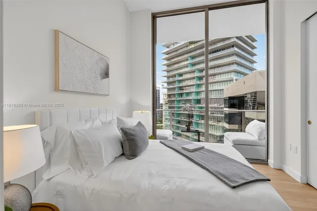 a bedroom with a bed and a large window