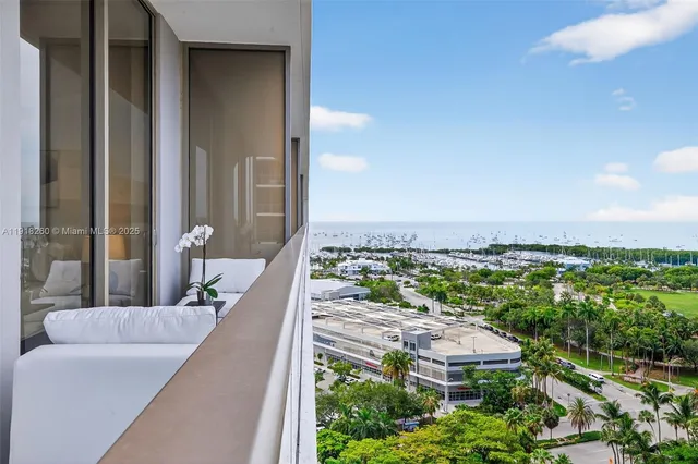 a view of a balcony with an outdoor seating and a garden