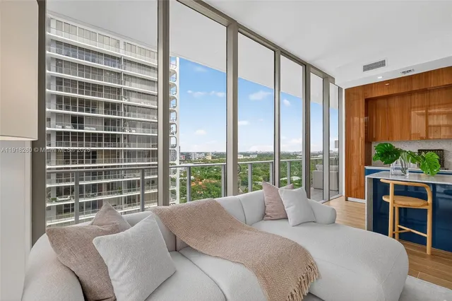 a bedroom with a large window and a bed