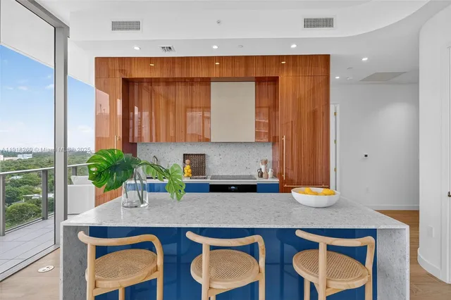 a kitchen with a sink a table and chairs in it