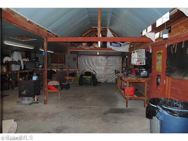 7026 Penman Road High Point, NC 27263 - Photo 14 of 16 Stable/Barn. Inside of barn. currently used as storage offers concrete floor, metal exterior and 3 stalls