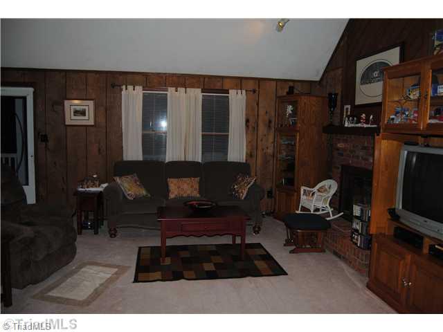 7026 Penman Road High Point, NC 27263 - Photo 7 of 16 Living Room. Cozy updated living area offers brick fireplace with gas logs for those chilly winter nights