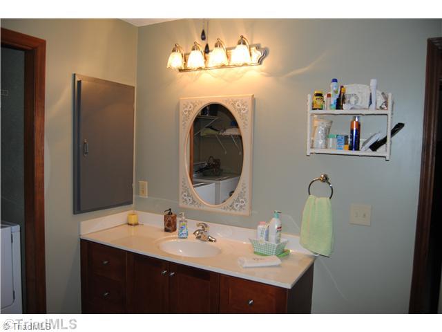 7026 Penman Road High Point, NC 27263 - Photo 10 of 16 Master Bath/Spa. Master bath in on main level and laundry room is conveniently located within bath. Updated bath includes jetted tub