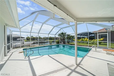 a view of a patio with table and chairs under an umbrella