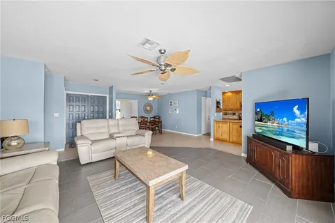 a living room with a couch and a chandelier
