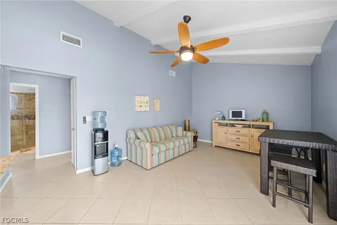 a kitchen with stainless steel appliances kitchen island granite countertop a table and chairs in it