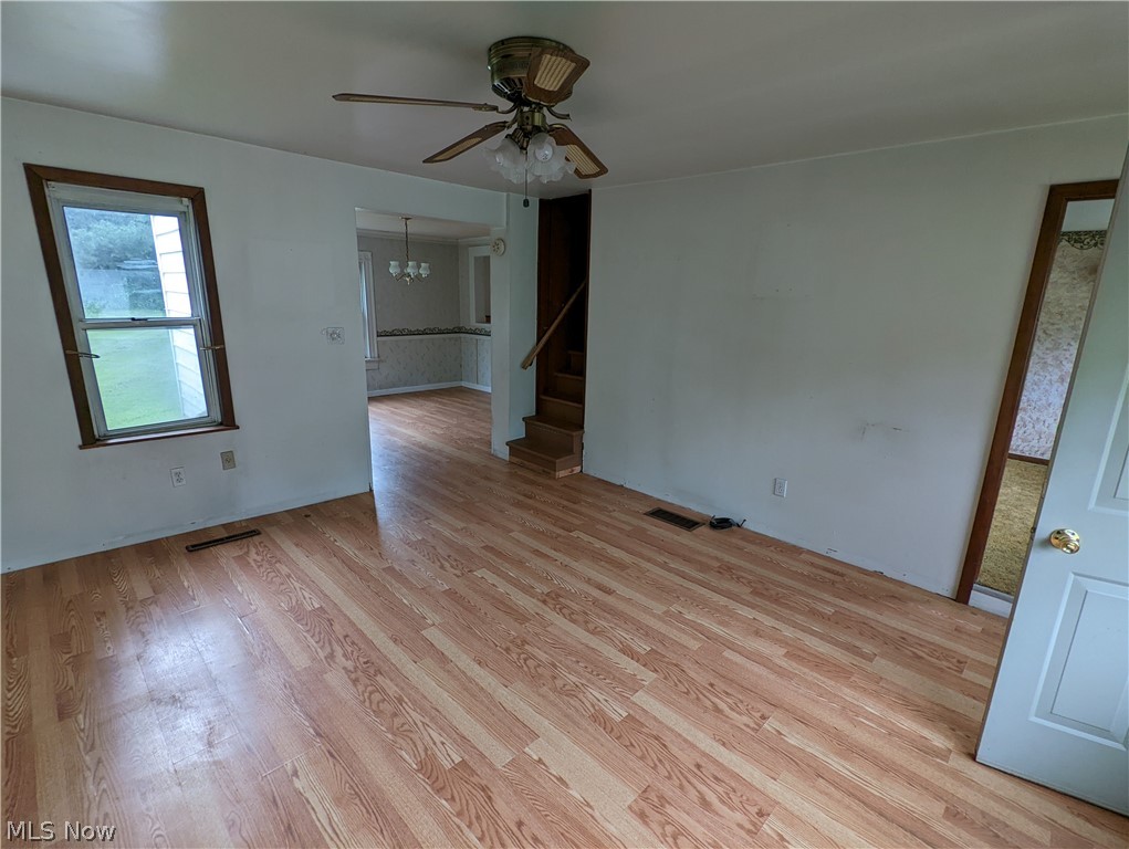 308 Thomas Road Lisbon, OH 44432 - Photo 3 of 13 Unfurnished room featuring light hardwood / wood-style flooring and ceiling fan with notable chandelier