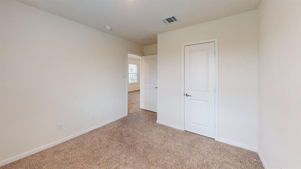 1306 Colonial Bluff Lane Princeton, TX 75407 - Photo 12 of 27 Neutral-toned carpeting throughout the room