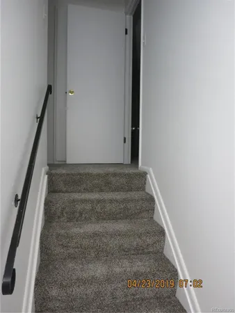 a view of staircase with white walls