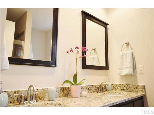 2405 Countrywood Road Raleigh, NC 27615 - Photo 14 of 25 Guest bath on first level adjoining the study has been totally redone with granite counter and a new shower. The shower has lovely, detailed tilework and a rimless clean glass door with nickel fixtures. The study next door has a closet and new carpet. Bathroom