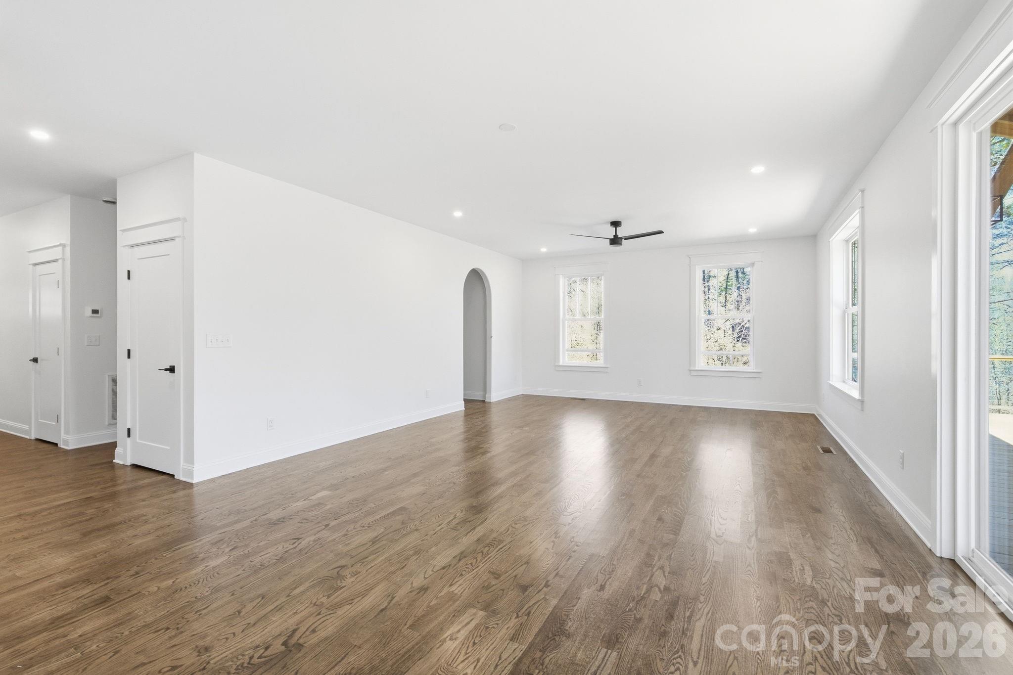 22 Deep Woods Road Weaverville, NC 28787 - Photo 11 of 37 an empty room with wooden floor and windows