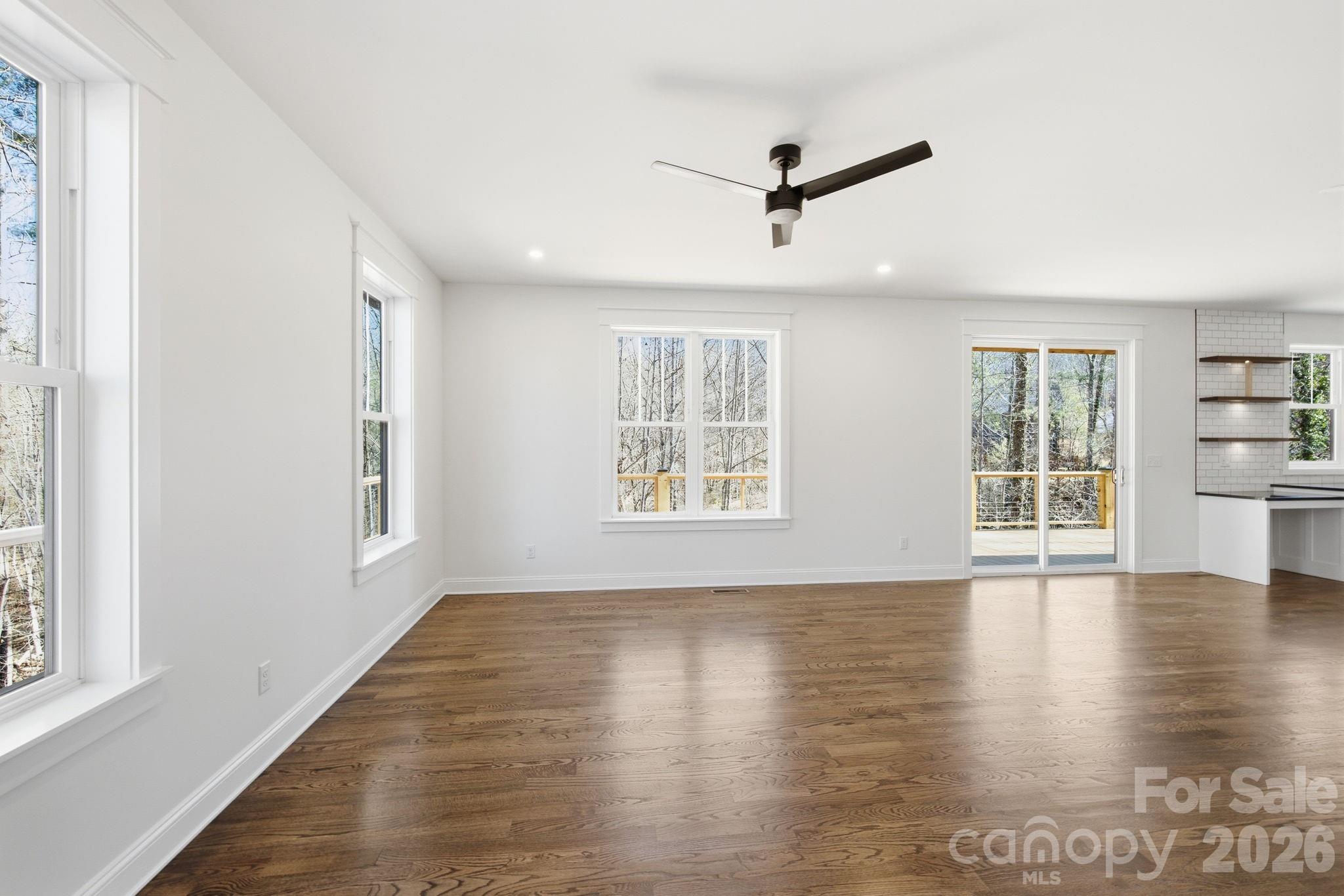 22 Deep Woods Road Weaverville, NC 28787 - Photo 12 of 37 a view of an empty room with wooden floor and a window