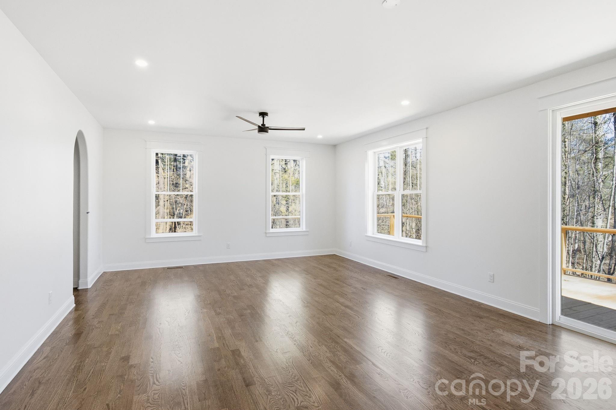 22 Deep Woods Road Weaverville, NC 28787 - Photo 13 of 37 a view of an empty room with wooden floor and a window