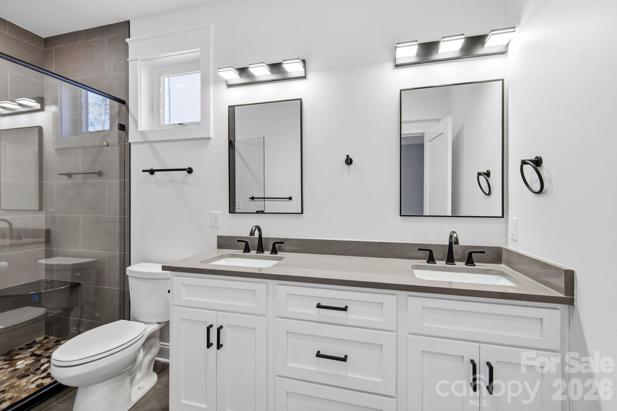 22 Deep Woods Road Weaverville, NC 28787 - Photo 15 of 37 a bathroom with a toilet sink and mirror