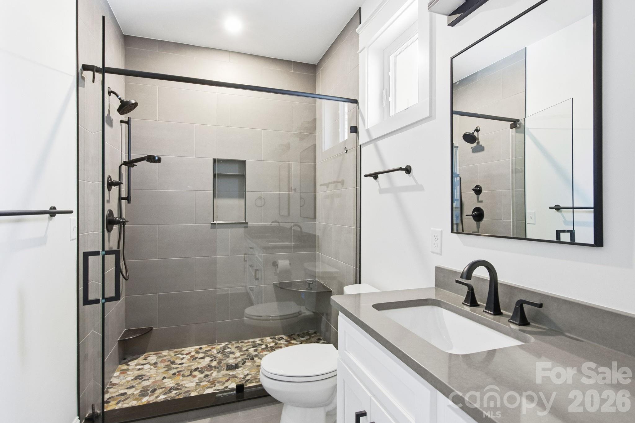 22 Deep Woods Road Weaverville, NC 28787 - Photo 16 of 37 a bathroom with a sink granite toilet and shower