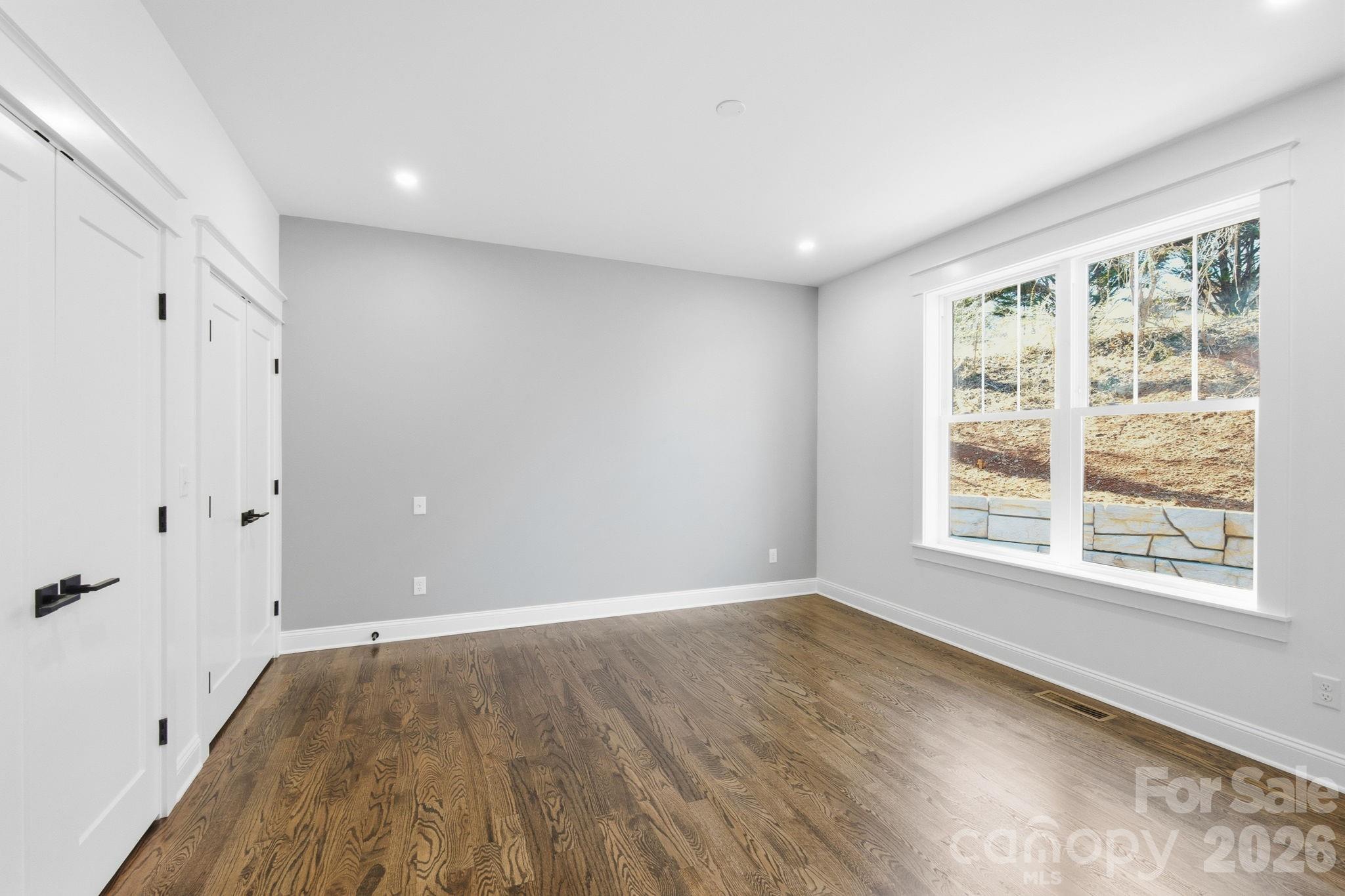 22 Deep Woods Road Weaverville, NC 28787 - Photo 20 of 37 a view of an empty room with wooden floor and a window