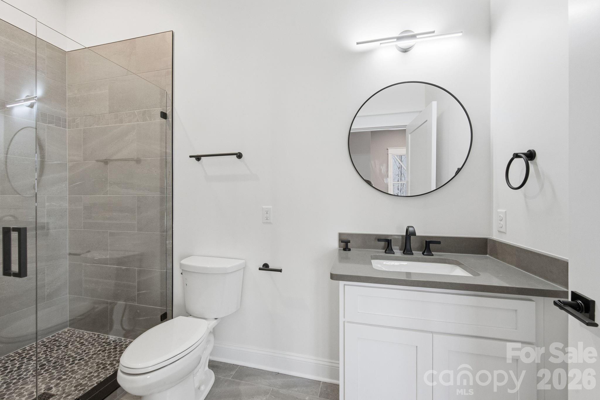 22 Deep Woods Road Weaverville, NC 28787 - Photo 28 of 37 a bathroom with a toilet a sink and mirror