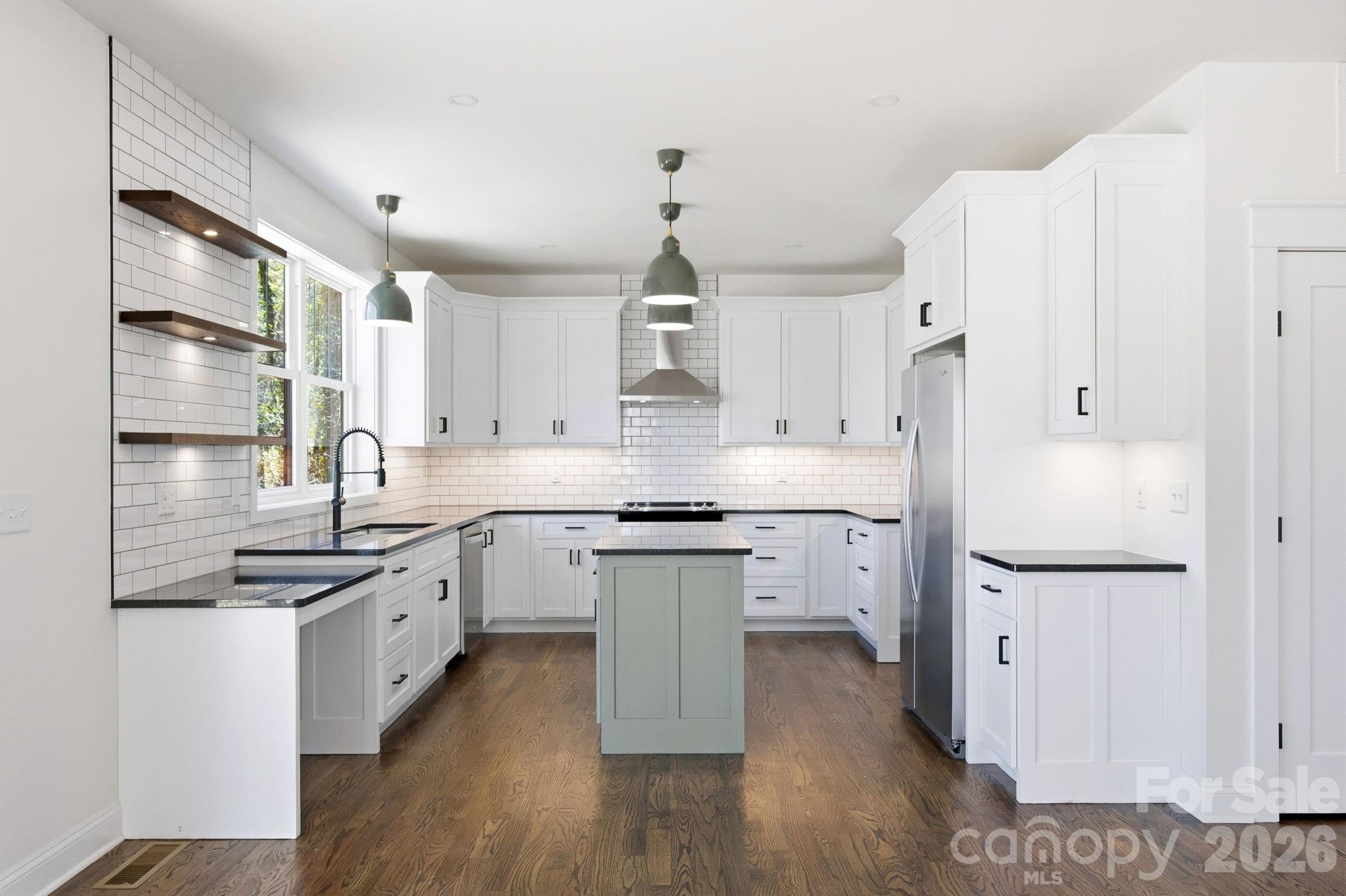 22 Deep Woods Road Weaverville, NC 28787 - Photo 5 of 37 a kitchen with a sink stove cabinets and wooden floor