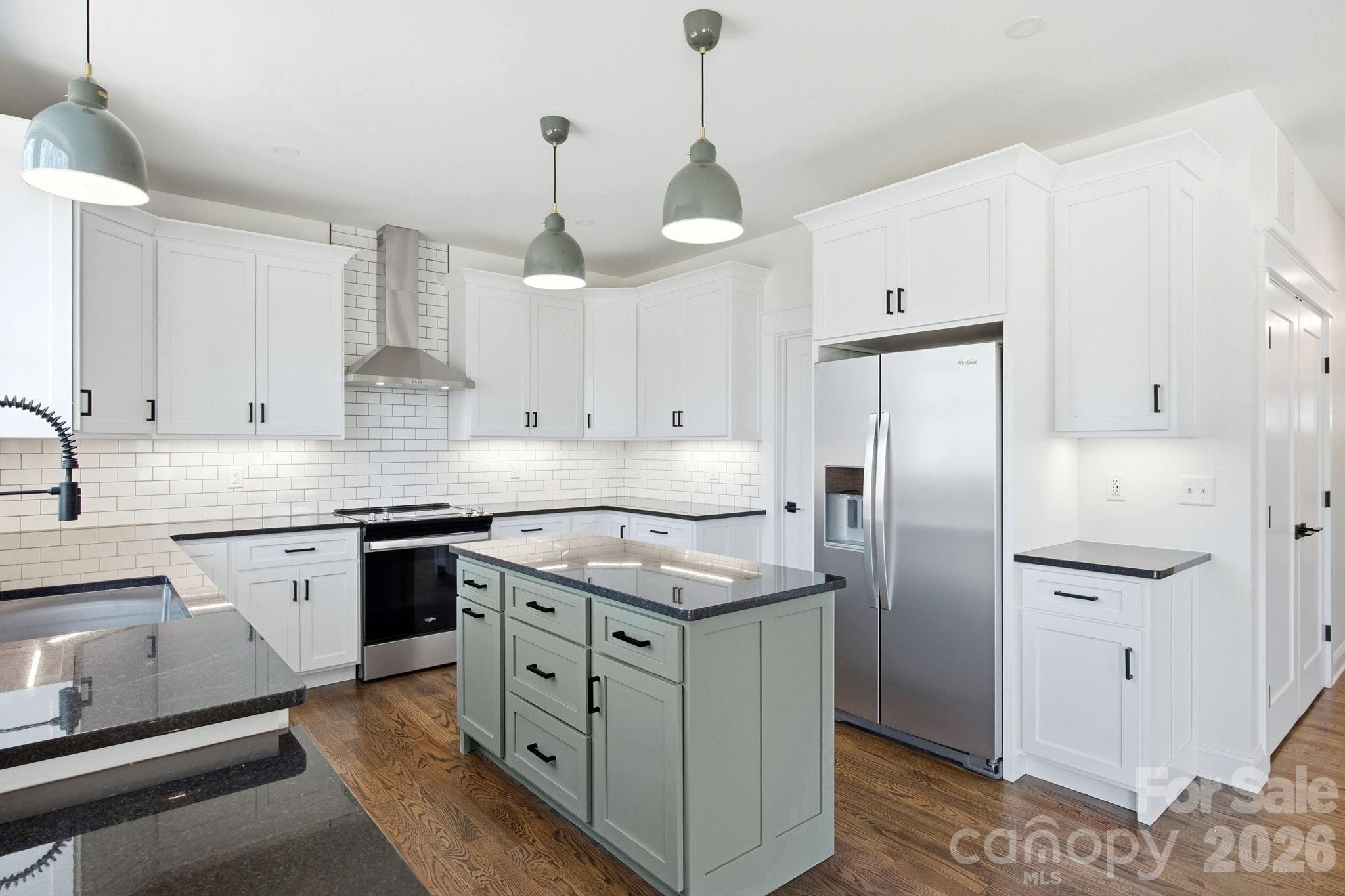 22 Deep Woods Road Weaverville, NC 28787 - Photo 6 of 37 a kitchen with stainless steel appliances granite countertop a sink a stove a refrigerator and island
